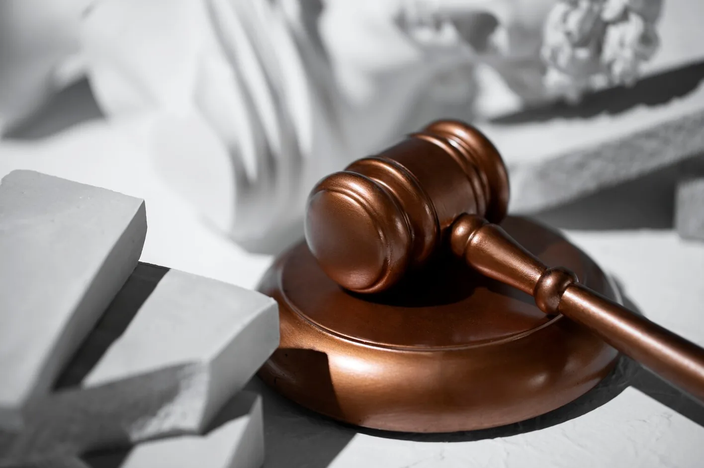 A judge's gavel among broken concrete blocks