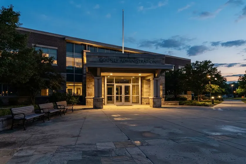 The entrance of a county administration building at dusk
